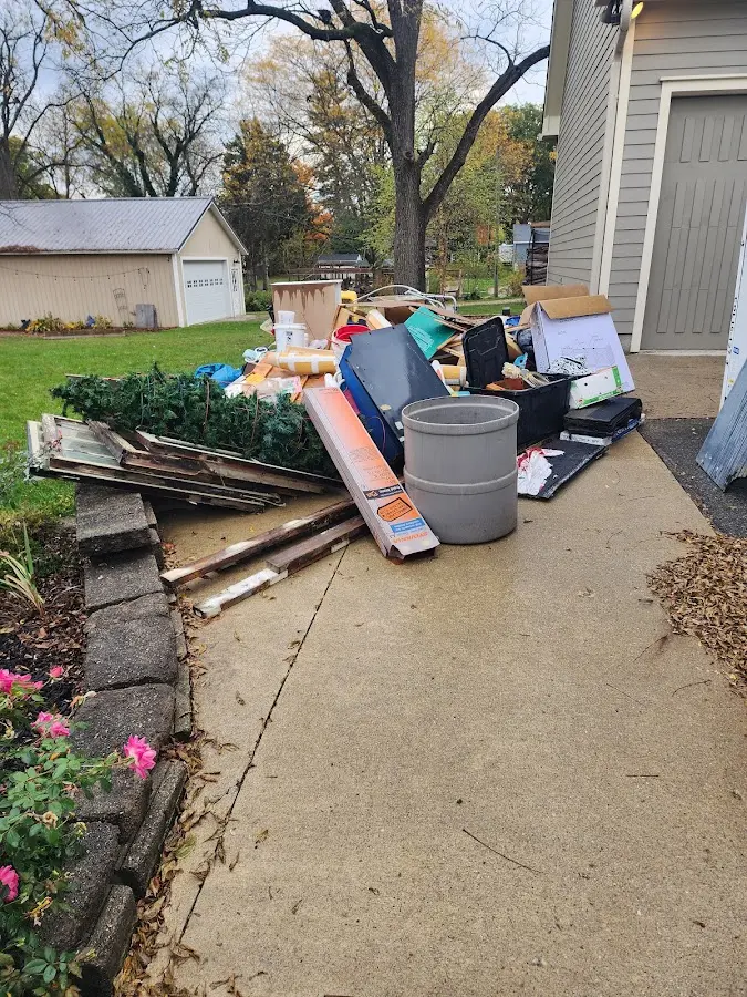 Dumpster being loaded with debris for 12 Yard Dumpster Rental in Glenwood Springs